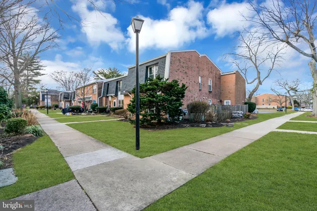 a house view with garden space and trees