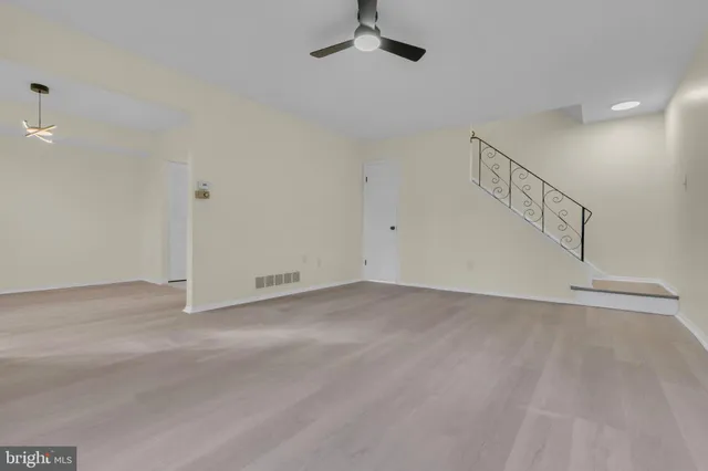 a view of an empty room with stairs