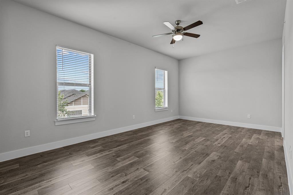 3281 Ganzer Road West, Unit 817A Denton, TX 76207 - Photo 21 of 40 an empty room with wooden floor and windows
