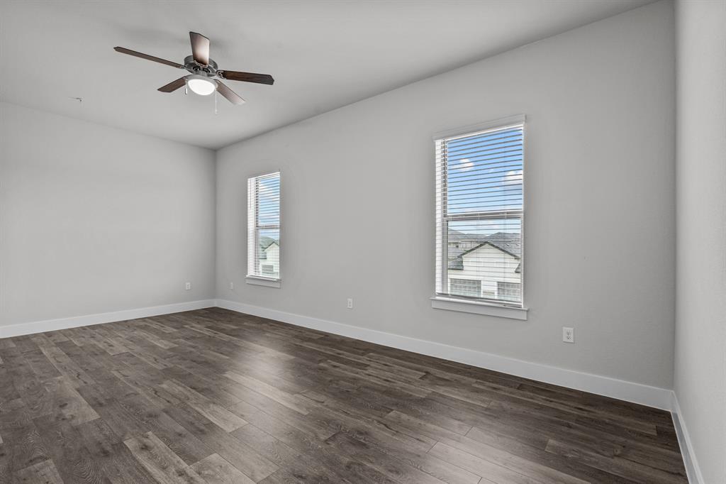 3281 Ganzer Road West, Unit 817A Denton, TX 76207 - Photo 24 of 40 a view of an empty room with a window and wooden floor