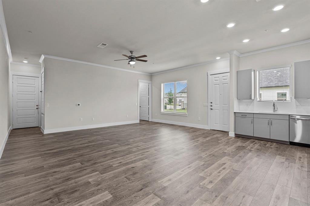 3281 Ganzer Road West, Unit 817A Denton, TX 76207 - Photo 3 of 40 a view of an empty room with a window and wooden floor