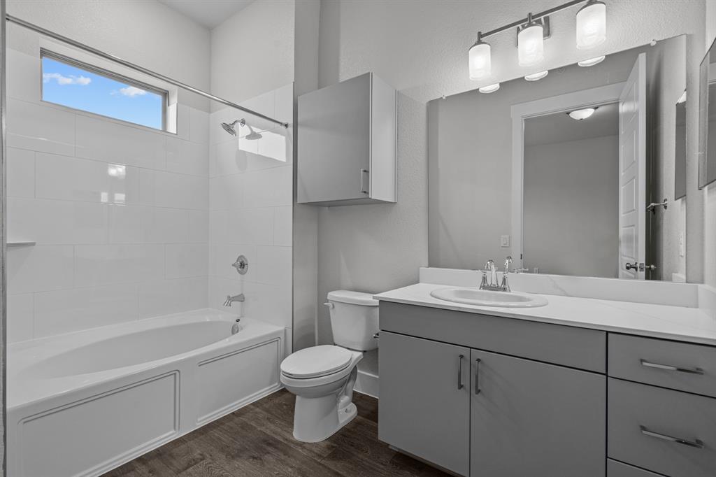 3281 Ganzer Road West, Unit 817A Denton, TX 76207 - Photo 34 of 40 a bathroom with a sink toilet and shower