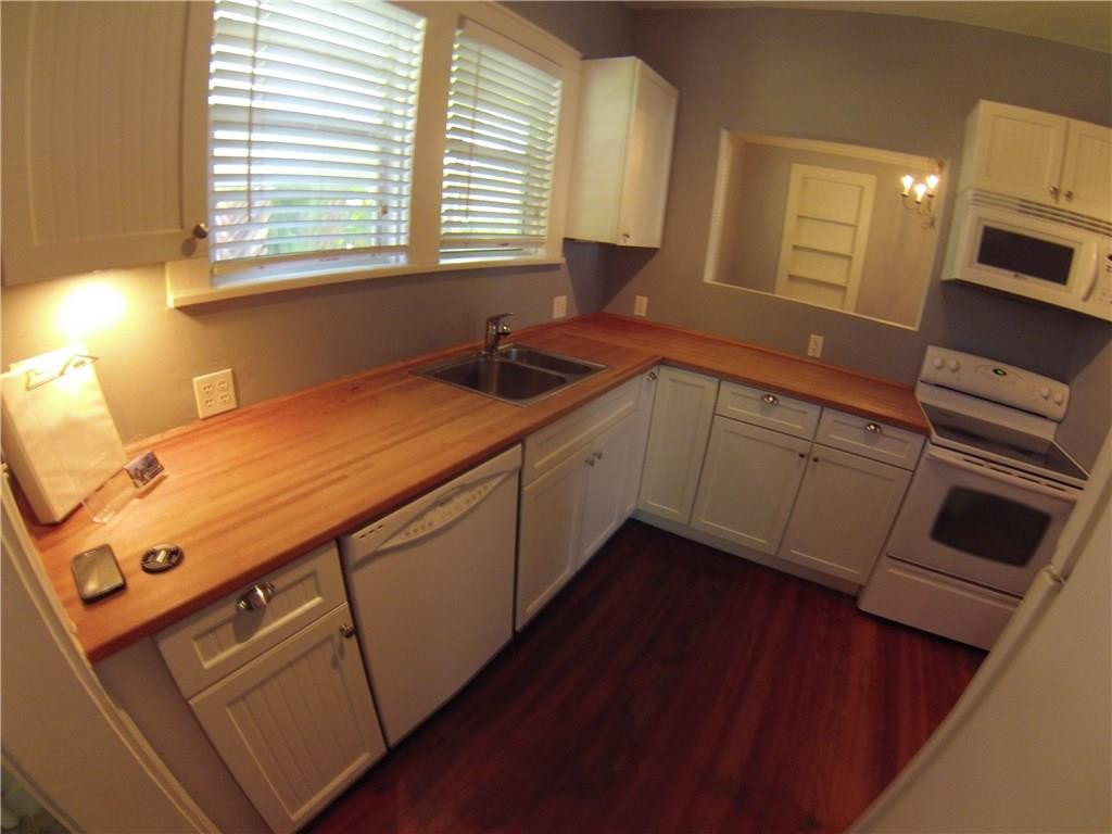 1719 Adams Street Hollywood, FL 33020 - Photo 12 of 29 a kitchen with a sink cabinets appliances and a window