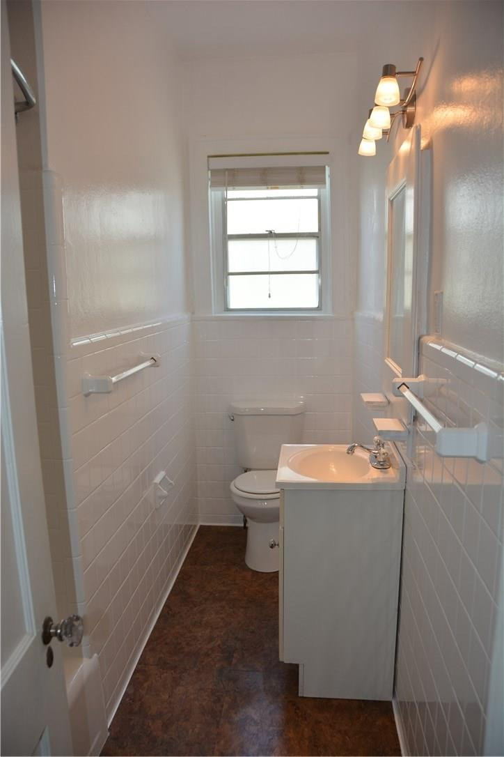 1719 Adams Street Hollywood, FL 33020 - Photo 26 of 29 a bathroom with a sink a toilet and a mirror