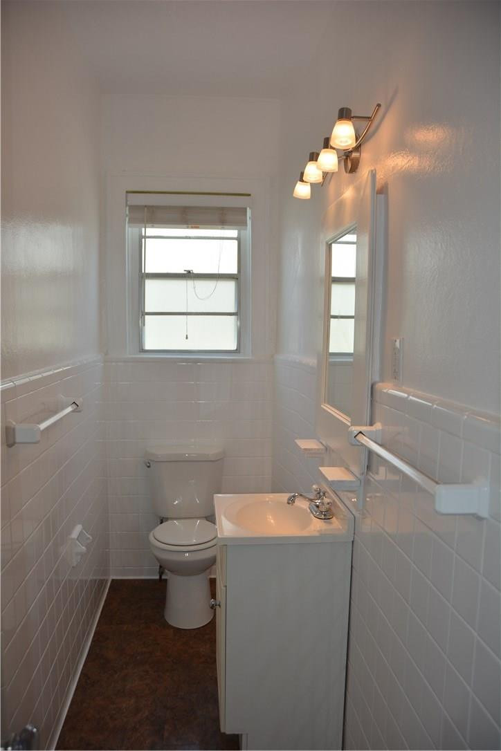 1719 Adams Street Hollywood, FL 33020 - Photo 29 of 29 a bathroom with a toilet sink and mirror