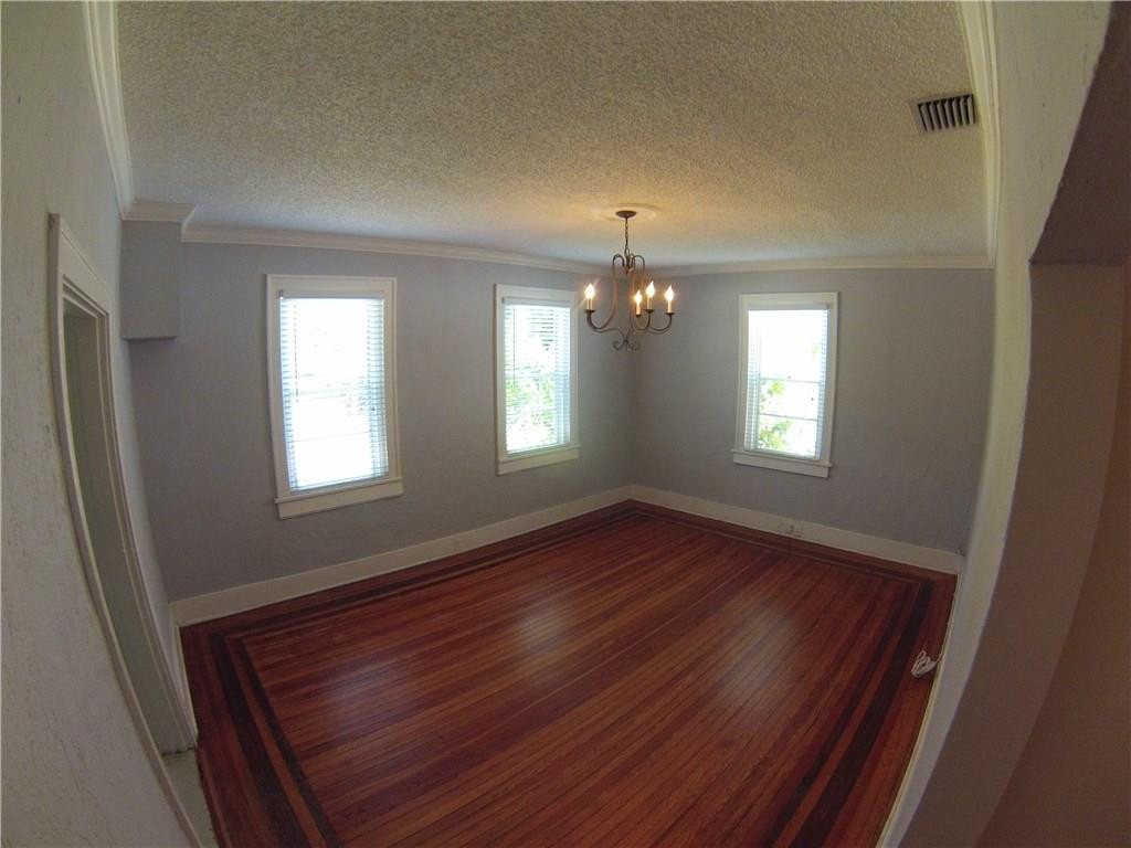 1719 Adams Street Hollywood, FL 33020 - Photo 3 of 29 a view of an empty room with wooden floor and a window