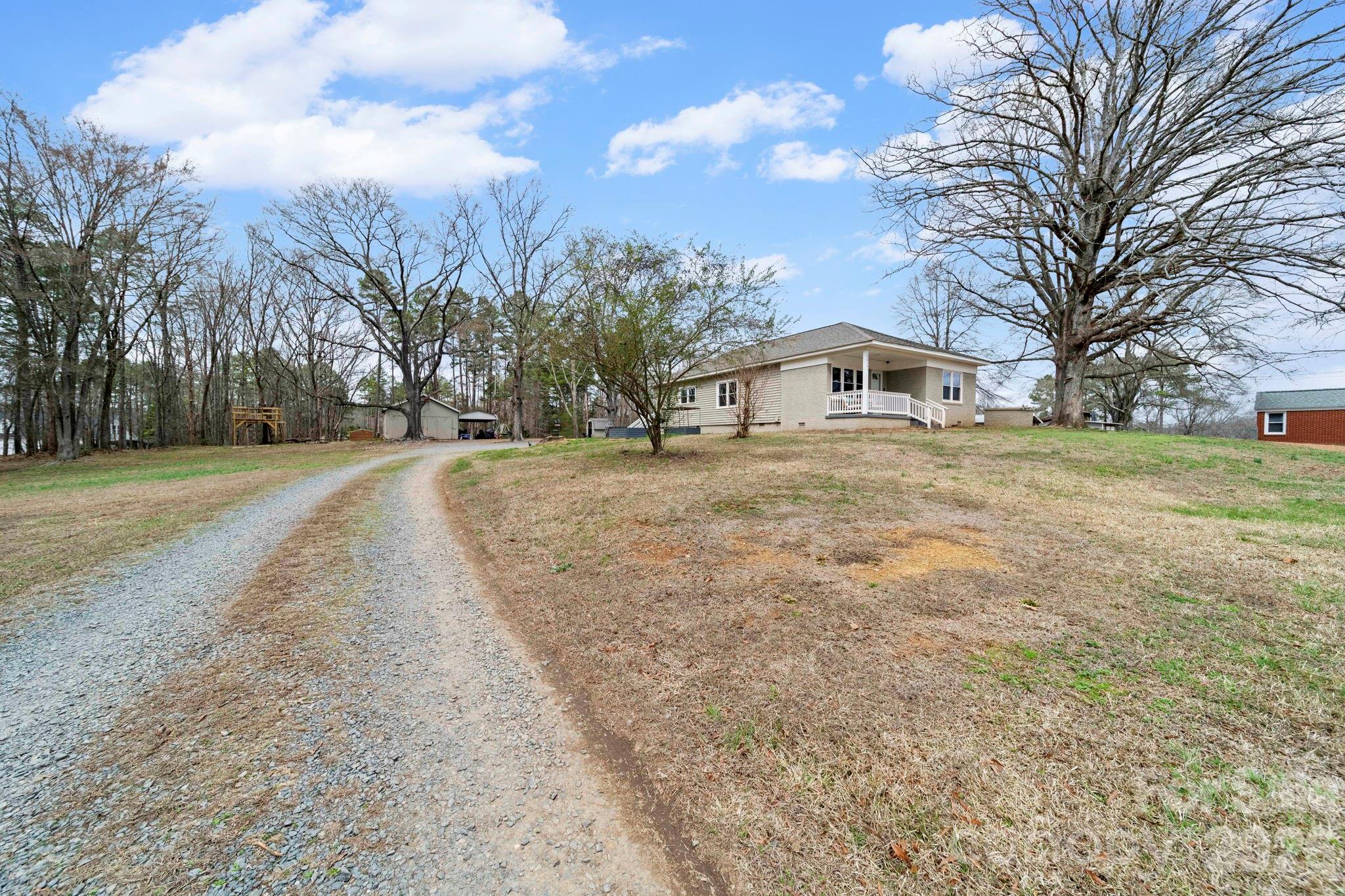 36141 Palestine Road Albemarle, NC 28001 - Photo 1 of 40 a big house with trees in front of it
