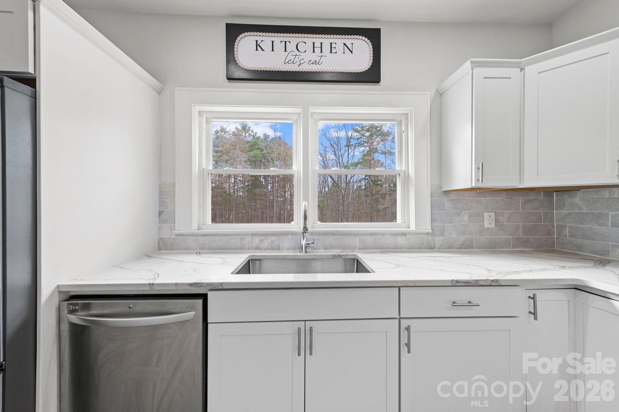 36141 Palestine Road Albemarle, NC 28001 - Photo 11 of 40 a kitchen with granite countertop a sink and a window