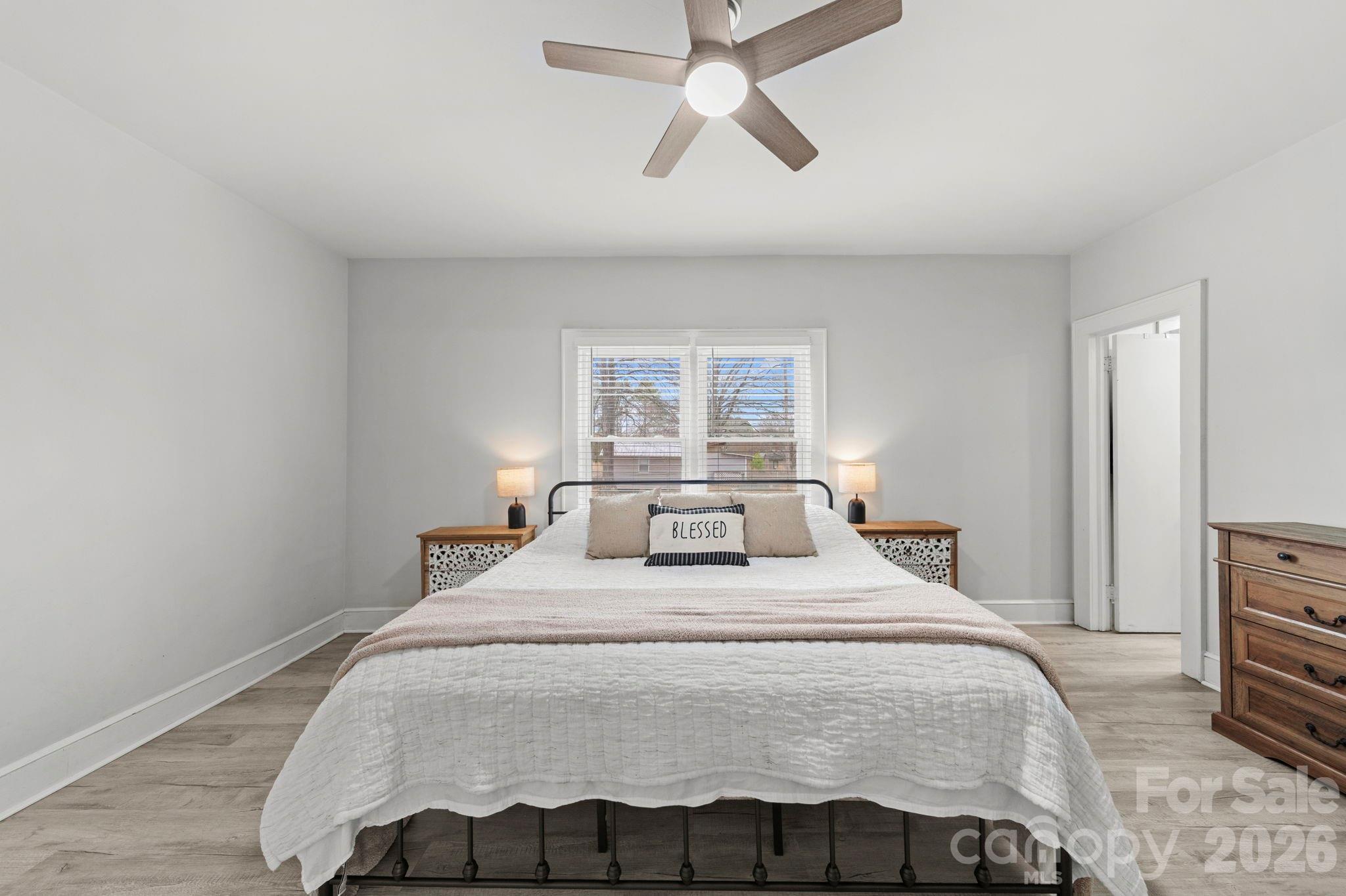 36141 Palestine Road Albemarle, NC 28001 - Photo 18 of 40 a bedroom with a bed and a chandelier