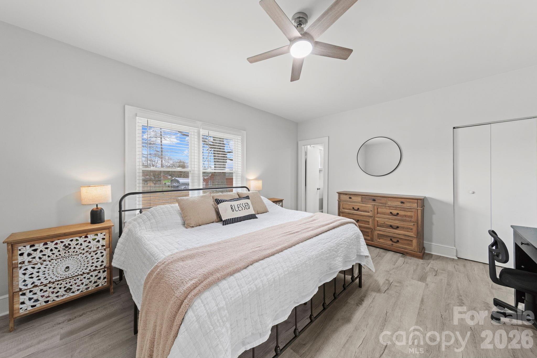 36141 Palestine Road Albemarle, NC 28001 - Photo 19 of 40 a bedroom with a bed and a chandelier