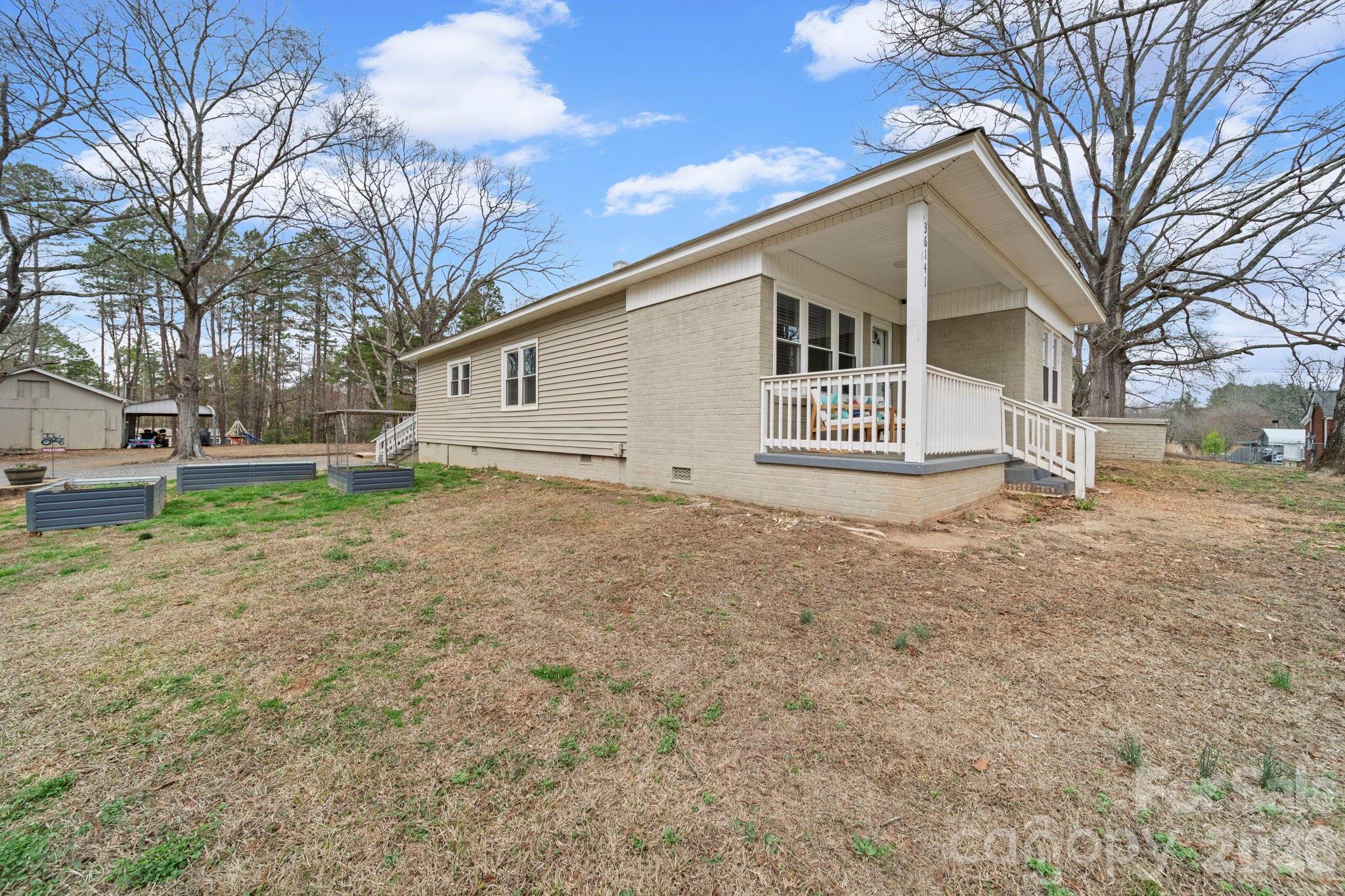 36141 Palestine Road Albemarle, NC 28001 - Photo 2 of 40 a view of a house with a yard and large tree