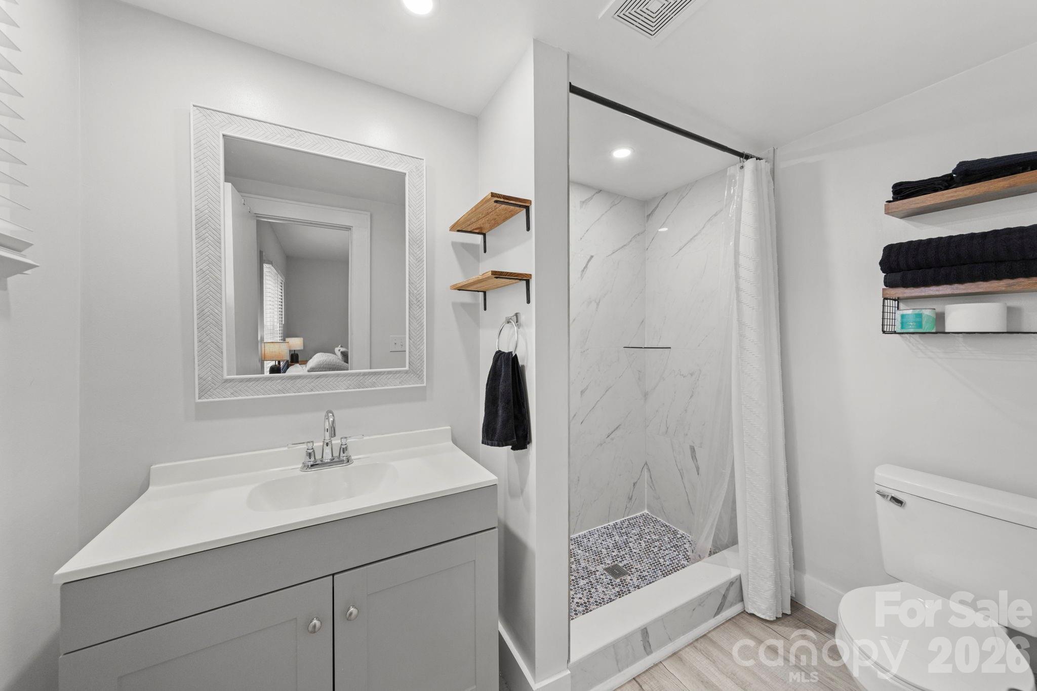 36141 Palestine Road Albemarle, NC 28001 - Photo 21 of 40 a bathroom with a sink a toilet and shower