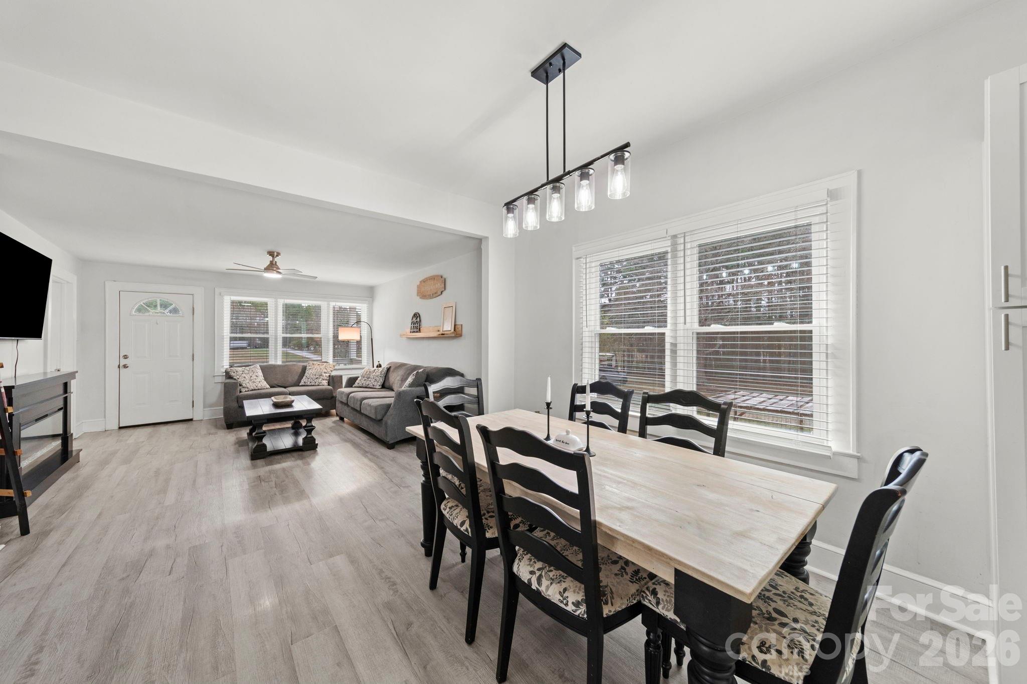 36141 Palestine Road Albemarle, NC 28001 - Photo 7 of 40 a view of a dining room and livingroom with furniture wooden floor a chandelier