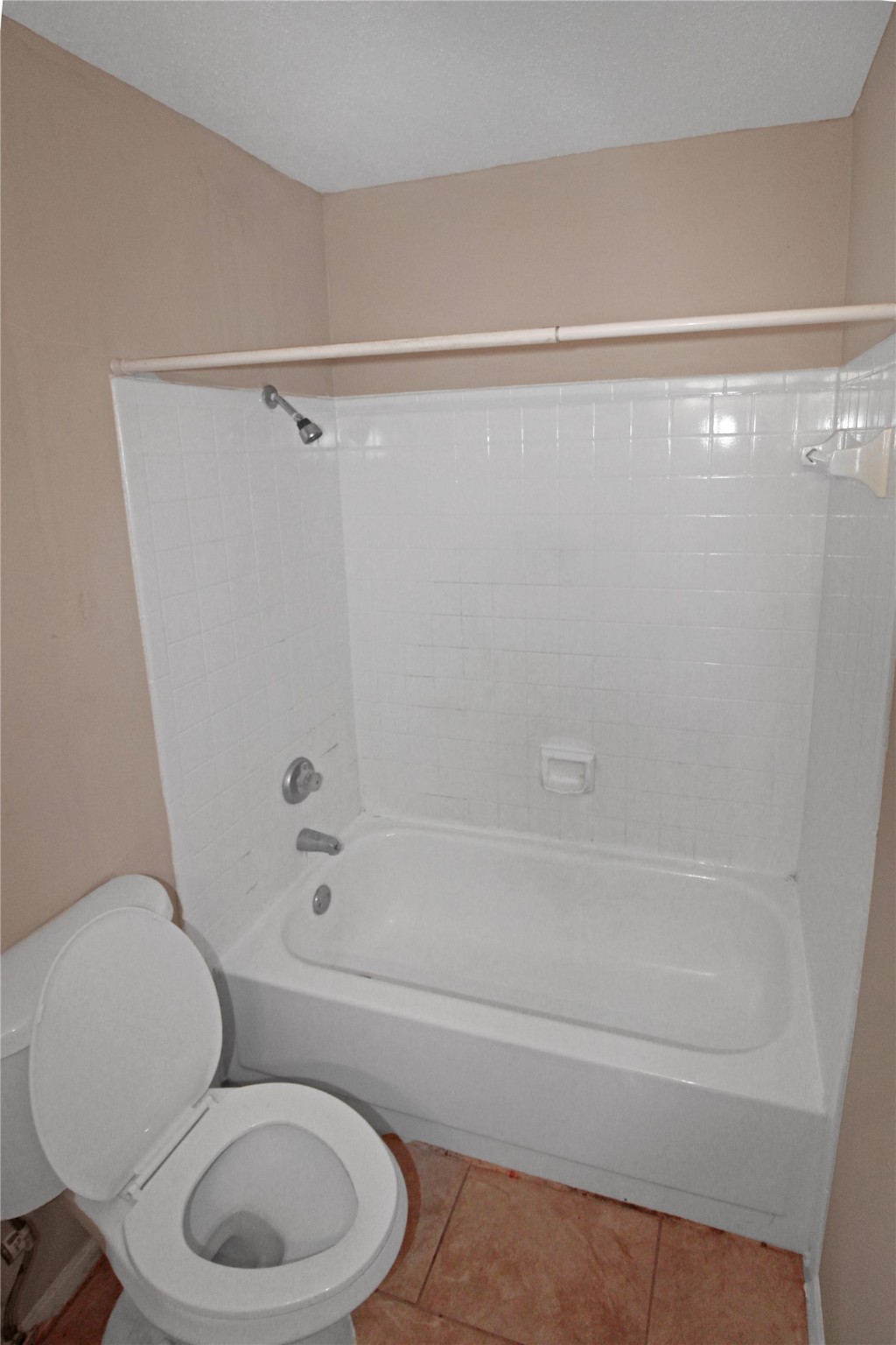 16303 Lyons School Road, Unit 313 Spring, TX 77379 - Photo 11 of 15 a white toilet and tub next to a shower