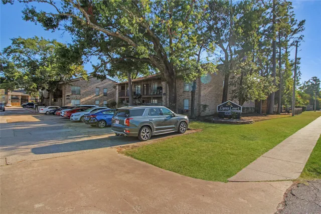 a front view of a building with parked cars