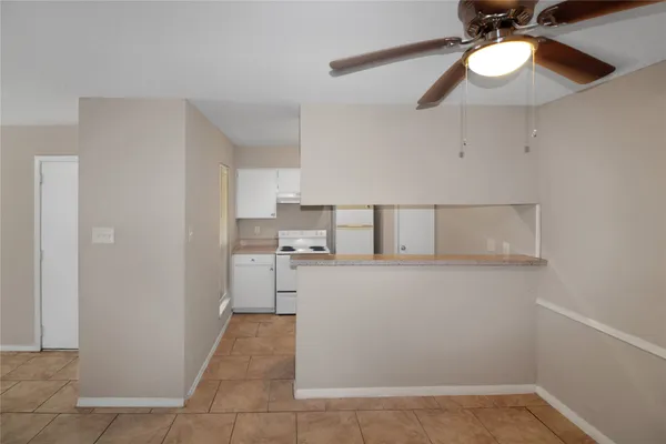 a kitchen with a cabinets and chandelier