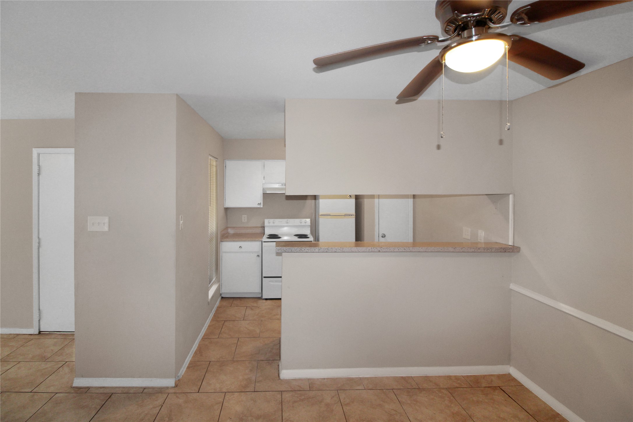 16303 Lyons School Road, Unit 313 Spring, TX 77379 - Photo 3 of 15 a kitchen with a cabinets and chandelier