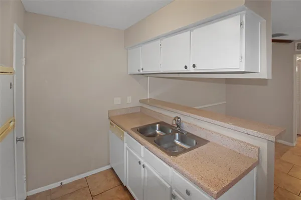 a kitchen with a sink cabinets and utility