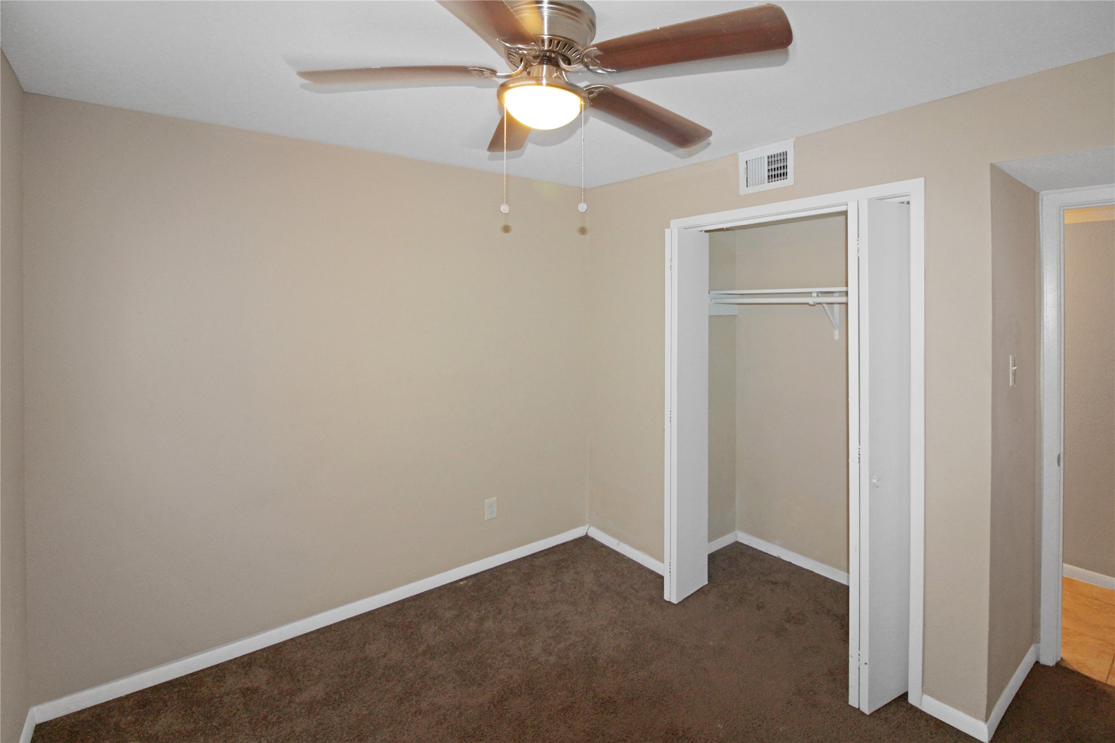 16303 Lyons School Road, Unit 313 Spring, TX 77379 - Photo 7 of 15 an empty room with closet and a chandelier fan
