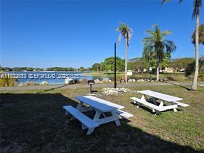 10360 Southwest 150th Court, Unit 12104 Miami, FL 33196 - Photo 13 of 23 a view of a swimming pool and lounge chairs