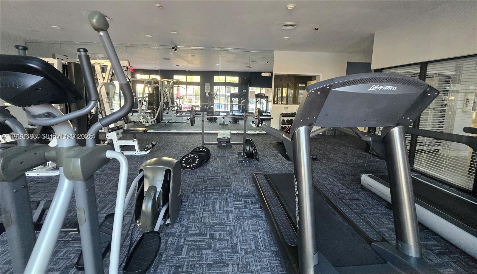 10360 Southwest 150th Court, Unit 12104 Miami, FL 33196 - Photo 14 of 23 a view of a room with gym equipment
