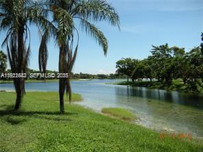 10360 Southwest 150th Court, Unit 12104 Miami, FL 33196 - Photo 15 of 23 a backyard of a house with lots of green space and lake view