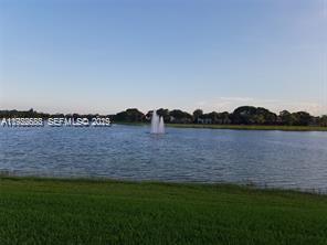 10360 Southwest 150th Court, Unit 12104 Miami, FL 33196 - Photo 17 of 23 a view of a lake with houses in the back