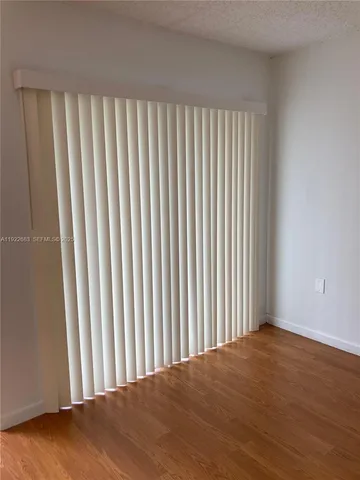 a view of a empty room with wooden floor