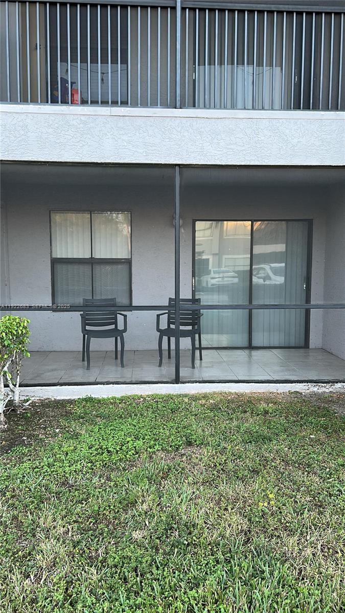 10360 Southwest 150th Court, Unit 12104 Miami, FL 33196 - Photo 9 of 23 a backyard of a house with table and chairs