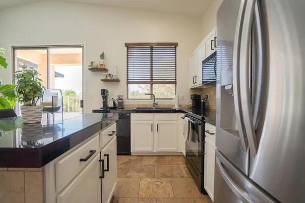 a kitchen with a refrigerator a sink and a large window