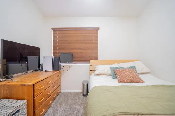 a bedroom with a bed and a flat screen tv