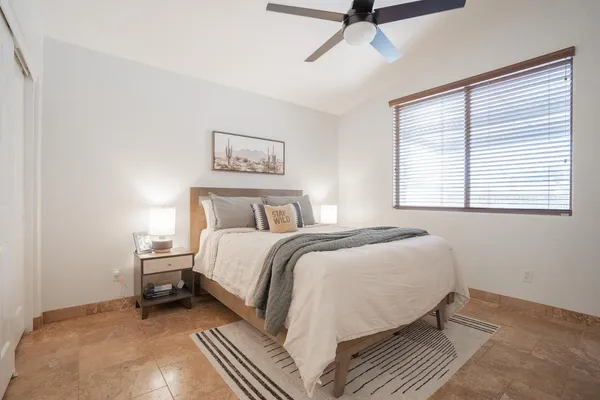 a bedroom with a bed and a window