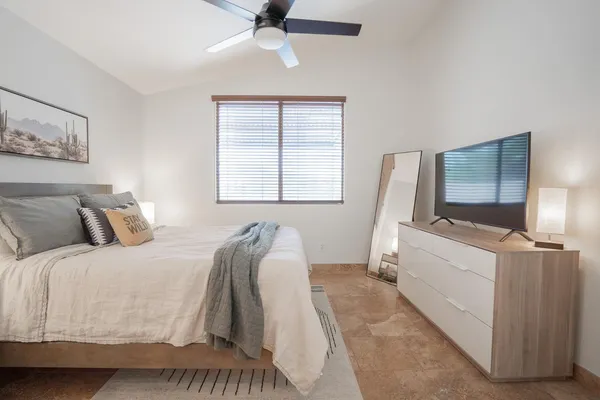 a bedroom with a bed and a flat screen tv