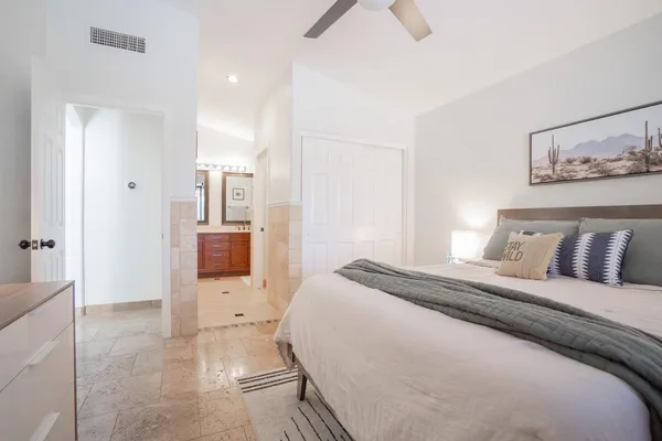 a spacious bedroom with a bed and a view of bathroom