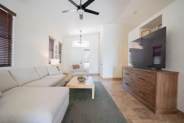 a living room with furniture and a flat screen tv