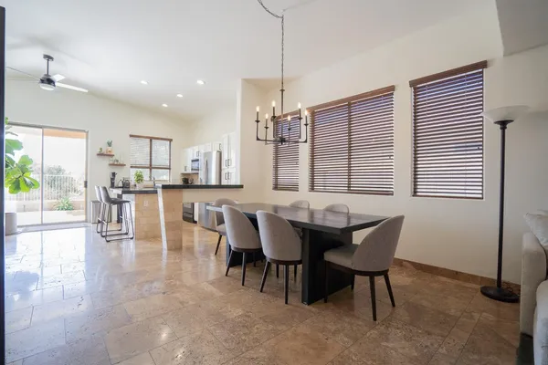 a dining room with furniture and wooden floor