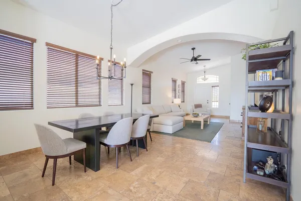 a living room with furniture and a chandelier