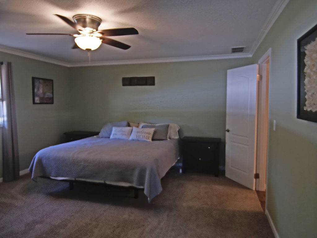 11 Kennedy Court Philo, IL 61864 - Photo 16 of 35 a bedroom with a bed and a chandelier