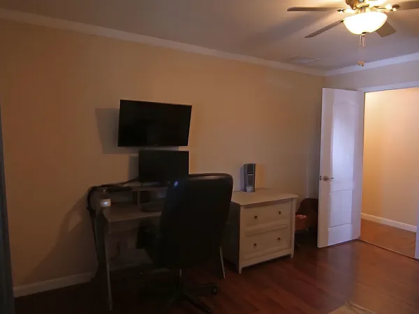 a view of a workspace with furniture and wooden floor