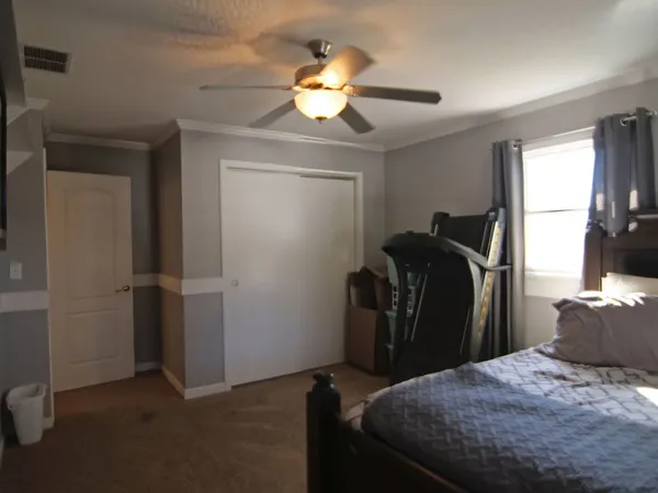 a bedroom with a bed and a chandelier