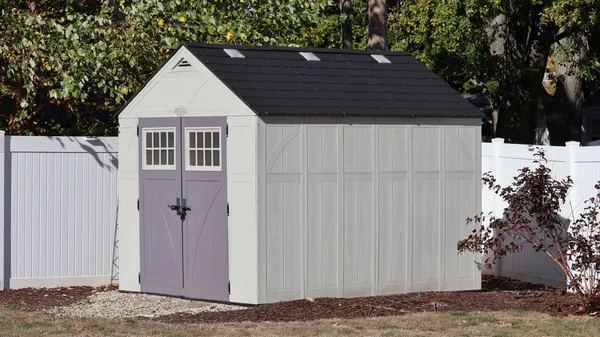 a view of a wooden house with a small yard