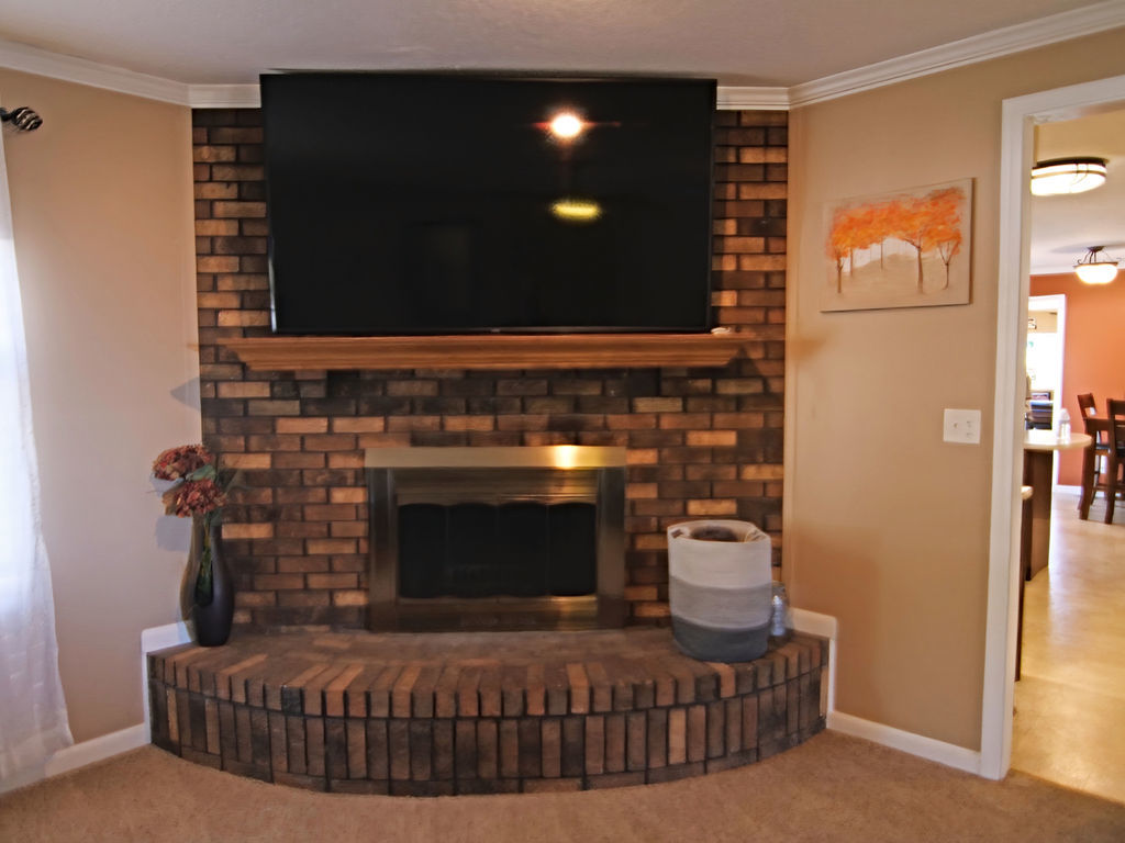 11 Kennedy Court Philo, IL 61864 - Photo 8 of 35 a living room with furniture a flat screen tv and a fireplace