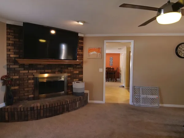 a view of a livingroom with a fireplace and couch