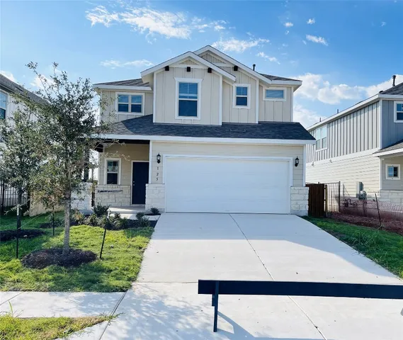 a view of house and outdoor space with garage