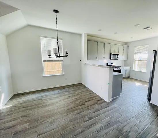 a kitchen with kitchen island a counter top space appliances and cabinets