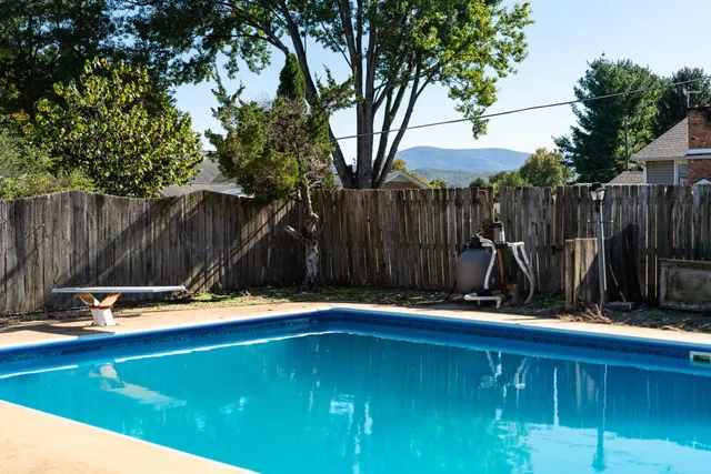 a wooden bench sitting in a backyard
