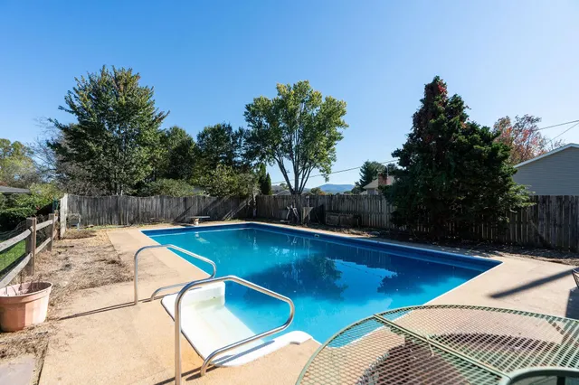 a view of a swimming pool with an outdoor space and seating area