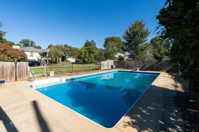 a view of a swimming pool with an outdoor seating and a garden
