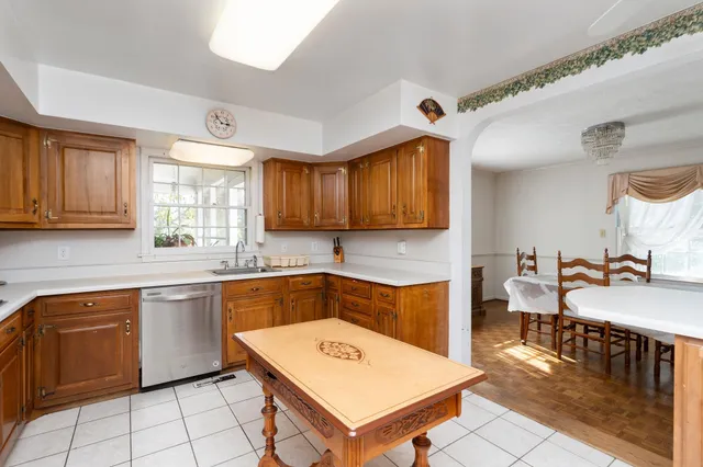 a kitchen with stainless steel appliances granite countertop a sink a stove counter space and cabinets