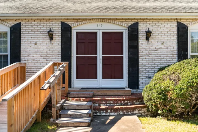a view of a balcony with a potted plant and stairs